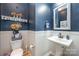 Stylish bathroom with pedestal sink, wainscoting, and decorative shelving at 2101 Darian Way, Waxhaw, NC 28173