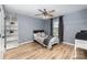 Light and airy bedroom with hardwood floors and built-in shelving at 2101 Darian Way, Waxhaw, NC 28173