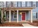 Red front door with white columns and brick walkway at 2101 Darian Way, Waxhaw, NC 28173