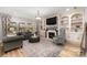 Living room with fireplace, built-in shelves, and large windows at 2101 Darian Way, Waxhaw, NC 28173