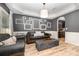 Living room with leather sofas, ottoman, and gallery wall at 2101 Darian Way, Waxhaw, NC 28173