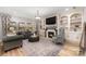 Living room with fireplace, built-in shelves, and large windows at 2101 Darian Way, Waxhaw, NC 28173