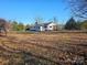 White house with covered porch and large yard at 211 Forgotten Ln, Bessemer City, NC 28016