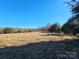 Open field with distant barn and fence at 211 Forgotten Ln, Bessemer City, NC 28016