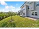 Landscaped backyard with deck and patio area at 2178 Grist Mill Dr, Concord, NC 28025