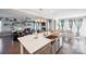 Kitchen island with sink, and breakfast bar seating, open to living room at 2178 Grist Mill Dr, Concord, NC 28025