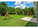 Lush backyard featuring a wooden playset, a concrete patio, and plenty of space for outdoor enjoyment at 247 Aylesbury Ln, Indian Trail, NC 28079