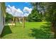 Spacious backyard featuring a wooden playset and a well-kept lawn, ideal for Gathering fun at 247 Aylesbury Ln, Indian Trail, NC 28079
