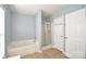 Bathroom featuring a bathtub, shower, and tile flooring at 247 Aylesbury Ln, Indian Trail, NC 28079