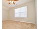 Bright bedroom featuring a large window and ceiling fan at 247 Aylesbury Ln, Indian Trail, NC 28079