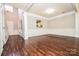 Two-story entryway with hardwood floors and white wainscoting at 247 Aylesbury Ln, Indian Trail, NC 28079