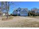 Two-story house with light gray siding, white garage door, and landscaping at 247 Aylesbury Ln, Indian Trail, NC 28079