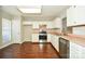 Bright kitchen featuring white cabinets, stainless steel appliances, and dark hardwood floors at 247 Aylesbury Ln, Indian Trail, NC 28079