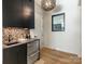 A modern bar area with sleek cabinets, stylish backsplash, and beverage cooler for entertaining at 2832 Arcadia Ave, Charlotte, NC 28209