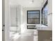 This bathroom boasts a glass shower, a sink with drawers, and a view from a large window at 2832 Arcadia Ave, Charlotte, NC 28209