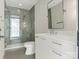 A modern bathroom boasts sleek fixtures, gray tile shower and a glass door at 2832 Arcadia Ave, Charlotte, NC 28209