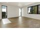 This well-lit bedroom boasts hardwood floors and multiple windows at 2832 Arcadia Ave, Charlotte, NC 28209