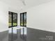 Bright, modern bedroom features polished concrete floors and expansive windows overlooking lush landscaping at 2832 Arcadia Ave, Charlotte, NC 28209