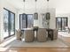 Elegant dining room featuring a modern table, pendant lighting, and natural light from expansive windows at 2832 Arcadia Ave, Charlotte, NC 28209