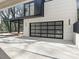 Spacious modern garage featuring a glass garage door and concrete driveway at 2832 Arcadia Ave, Charlotte, NC 28209