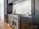 Gourmet kitchen features stainless steel appliances, a marble backsplash, and custom dark wood cabinets at 2832 Arcadia Ave, Charlotte, NC 28209