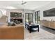 Open living room with modern decor, sleek flooring, and a kitchenette visible through an expansive doorway at 2832 Arcadia Ave, Charlotte, NC 28209