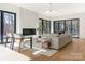 Bright living room with large windows, a modern fireplace, stylish seating, and hardwood floors at 2832 Arcadia Ave, Charlotte, NC 28209