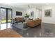 Bright living room with sleek floors, modern decor, and large windows to the yard at 2832 Arcadia Ave, Charlotte, NC 28209