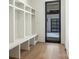 Well-organized mudroom with cubbies, bench seating, and an entry door to the garage at 2832 Arcadia Ave, Charlotte, NC 28209