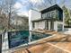 Stunning modern home with a luxurious pool, deck, and outdoor seating area perfect for entertaining at 2832 Arcadia Ave, Charlotte, NC 28209