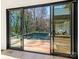 Outdoor pool area with clear glass doors and wood decking, perfect for relaxation at 2832 Arcadia Ave, Charlotte, NC 28209