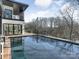 Beautiful pool with the house behind it overlooking a wooded area with some nature trails and a fence at 2832 Arcadia Ave, Charlotte, NC 28209