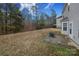 Backyard with patio and wooded area beyond at 3111 Hendricks Chapel Ln, Charlotte, NC 28216