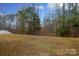 Large backyard with wooded area and fire pit at 3111 Hendricks Chapel Ln, Charlotte, NC 28216