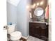 Powder room with dark vanity and granite countertop at 3111 Hendricks Chapel Ln, Charlotte, NC 28216