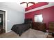 Bedroom with dark-colored furniture and red accent wall at 3111 Hendricks Chapel Ln, Charlotte, NC 28216