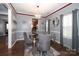 Dining room with a glass table, grey chairs, and a chandelier at 3111 Hendricks Chapel Ln, Charlotte, NC 28216