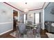 Formal dining room with glass table and grey upholstered chairs at 3111 Hendricks Chapel Ln, Charlotte, NC 28216