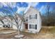 Two-story house with attached garage, landscaping, and a tree in the front yard at 3111 Hendricks Chapel Ln, Charlotte, NC 28216