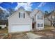 Two-story house featuring a two-car garage and manicured lawn at 3111 Hendricks Chapel Ln, Charlotte, NC 28216