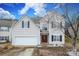 Two-story house with a white garage door and landscaping at 3111 Hendricks Chapel Ln, Charlotte, NC 28216