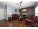 Living room with fireplace, hardwood floors, and leather furniture at 3111 Hendricks Chapel Ln, Charlotte, NC 28216