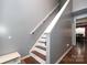 Staircase with hardwood flooring and a simple handrail at 3111 Hendricks Chapel Ln, Charlotte, NC 28216