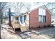 Back of house with deck, landscaping, and brick chimney at 318 S Rhyne St, Dallas, NC 28034