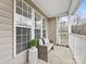 Covered balcony with wicker seating, perfect for enjoying the outdoors at 3264 Margellina Dr, Charlotte, NC 28210