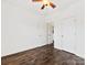 Simple bedroom with dark hardwood floors and ceiling fan at 3264 Margellina Dr, Charlotte, NC 28210