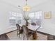 Light and bright dining area with wood table and chairs at 3264 Margellina Dr, Charlotte, NC 28210