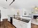 Kitchen with granite island, white cabinets, and dark floors at 3264 Margellina Dr, Charlotte, NC 28210