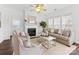 Bright living room features a fireplace, hardwood floors, and ample natural light at 3264 Margellina Dr, Charlotte, NC 28210