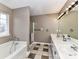 Bathroom featuring a bathtub, shower, double sink vanity with white countertop and white cabinets, and a large mirror at 3605 Truxton Ct, Waxhaw, NC 28173